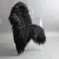 Black Icelandic sheepskin rug with long, curly wool laid flat.