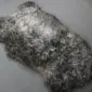 Grey Curly Gotland Sheepskin Rug GOT155 (4) Large curly sheepskin rug in natural grey with a textured, woolly surface and irregular organic shape.