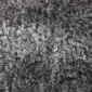 Close-up of a natural grey Gotland sheepskin rug featuring dense, curly wool texture.