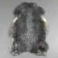 Natural grey Gotland sheepskin rug with curly wool and an irregular organic shape.