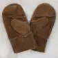 A pair of brown suede children's mittens with visible stitching and sheepskin lining.