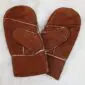 A pair of brown suede children's mittens with visible cream sheepskin lining at the seams.