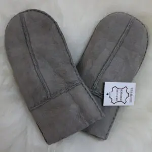 A pair of grey suede sheepskin mittens with visible stitching and folded cuffs.