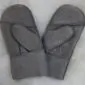 A pair of grey suede sheepskin mittens for children with visible stitching and folded cuffs.