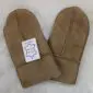 A pair of light brown suede kids sheepskin mittens with visible stitching and a white product tag.