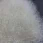 Close-up of ivory Mongolian lambskin rug showing long, curly wool texture.