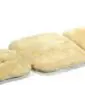 Cream-coloured padded sheepskin stroller liner with a soft, woolly texture and shaped sections.