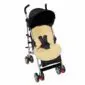 Cream sheepskin stroller liner with harness slots fitted inside a black pushchair.