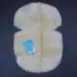 Cream sheepskin stroller liner with pre-cut harness slots and a soft suede reverse side.