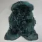 Bottle green sheepskin rug with a thick, textured wool pile and natural organic shape.