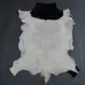 Natural goatskin rug with a large white centre and black markings at the top and bottom edges.