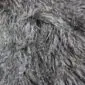 IMG_1456 Close-up of a sand-coloured Mongolian lambskin rug featuring long, curly and textured wool fibres.