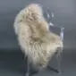Long-haired Icelandic sheepskin rug in a nude beige tone laid flat.