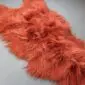 Terracotta orange Icelandic sheepskin rug with long, shaggy wool and natural organic shape.