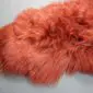 Terracotta orange Icelandic sheepskin rug with long, thick, shaggy wool fibres.