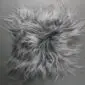 Square grey Icelandic sheepskin seat pad with long, shaggy wool fibres.