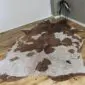 Brown and White Gold Metallic Cowhide Rug CM283 (2) Natural shaped cowhide rug with brown and white patches and rose gold metallic splatters. detail view