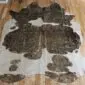 Brown and White Gold Metallic Cowhide Rug CM284 (3) Natural brown and white cowhide rug with metallic gold speckles and an irregular shape.
