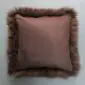 Square natural brown sheepskin cushion with a smooth suede-style centre and long wool trim around the edges.