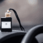 Black rectangular car air freshener with a white label, wooden cap and black hanging cord.
