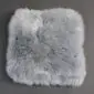 Square steel grey sheepskin seat pad with thick, textured wool pile.