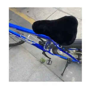 Black sheepskin bicycle seat cover fitted onto a blue bike frame.