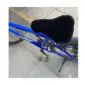 Black sheepskin bicycle seat cover fitted onto a blue bike frame.