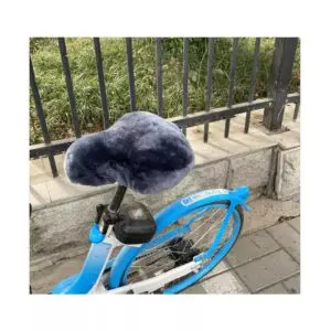 Grey sheepskin bicycle seat cover fitted onto a blue bicycle saddle.