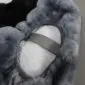 Underside of a grey sheepskin bicycle seat cover showing the elasticated edge and central fastening strap.