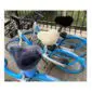 Three bicycles fitted with sheepskin seat covers in grey, cream and black.