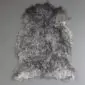 Natural grey curly sheepskin rug with a textured, woolly surface and irregular organic shape.