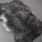 Grey Curly Gotland Sheepskin Rug GOT246 (4) Natural grey curly sheepskin rug with a textured, woolly surface and irregular organic shape.