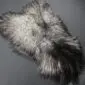 Natural grey Icelandic sheepskin rug with long, curly wool in variegated shades of silver, charcoal and cream.
