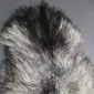 Natural grey Icelandic sheepskin rug with long, curly wool in variegated shades of charcoal and silver.