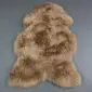 IMG_6313 Natural shaped camel coloured sheepskin rug with thick, textured wool pile.