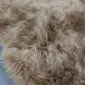 IMG_6329 Close-up of a camel-coloured British sheepskin rug with thick, textured wool pile.