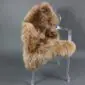 IMG_6331 Camel-coloured British sheepskin rug with thick, curly wool laid flat.