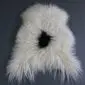 Natural white curly Icelandic sheepskin rug with a single black spot in the centre.