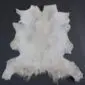 Goatskin Rug GS914 Natural white goatskin rug with long, textured fur and an irregular organic shape .