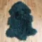 Curly Mongolian Sheepskin Rug Jungle Green Jungle green Mongolian lambskin rug with long, curly wool fibres and a natural hide shape.