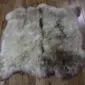 Large double sheepskin rug with long, thick wool in cream and grey tones.