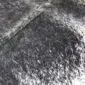 Cowhide Rug C00755 (4) Close-up of a speckled black and white cowhide rug showing natural hair texture and salt-and-pepper markings.