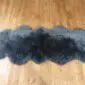 Sheepskin-Double-Grey-e Long, dark grey double sheepskin rug with a thick, fluffy texture and natural scalloped edges.