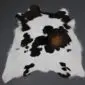 Natural calfskin rug with white base and irregular dark brown and black patches.