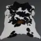 Calfskin Rug CF129 (3) Natural calfskin rug with a black and white speckled pattern and a central brown patch.