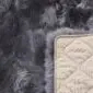 Dover 120x180 Back Close-up of a grey sheepskin rug showing the long wool pile and a cream quilted non-slip backing.