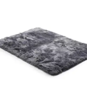 Rectangular grey sheepskin rug with a thick, textured pile shown from an angled perspective on a white background.