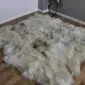 Large eight-skin rare breed sheepskin rug with long, textured wool in shades of cream, grey and brown.