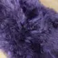 Close-up of a purple sheepskin rug with long, thick, textured wool fibres.