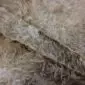 Cowhide Rug C00857 (4) Close-up of a caramel and grey cowhide rug showing the natural hair texture and folded edge.